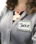 Close-up of person wearing a Classroom Cottage Name Tags And Labels Multi Pack For Teachers, Durable Multicolor Name Badge.