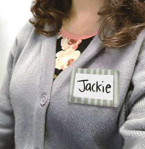 Close-up of person wearing a Classroom Cottage Name Tags And Labels Multi Pack For Teachers, Durable Multicolor Name Badge.