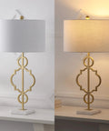 Gold Modern Quatrefoil LED Table Lamp with Marble Base and Linen Drum Shade on desk, showcasing light on and off states