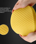 Heavy Cut Swirl Buster T80 Yellow Foam Polishing Pad with 6.5 Inch Face in hands, showing material quality and durability.