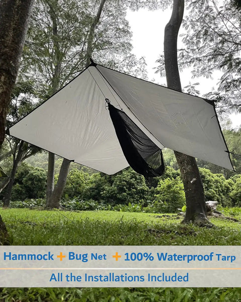 All In One Camping Hammock Kit With Rain Fly Tarp Netting And Go To Gear Waterproof Bundle shown in forest setup