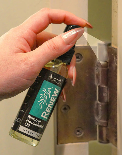 Hand using Renew Natural Household Oil Unscented All Purpose Lubricant Spray For Doors Hinges And Locks Eco Conscious Safe For Pets
