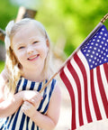 Child holding 50 Pack USA Stick Flags 12 By 18 Inch Small Flags With Wooden Poles And Spear Tips for outdoor celebration