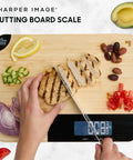 Person slicing chicken on Bamboo Cutting Board With Built In Digital Scale For Quick Meal Prep And Precise Weighing In Grams And Ounces 33 Lb Capacity Multipurpose Prep Board