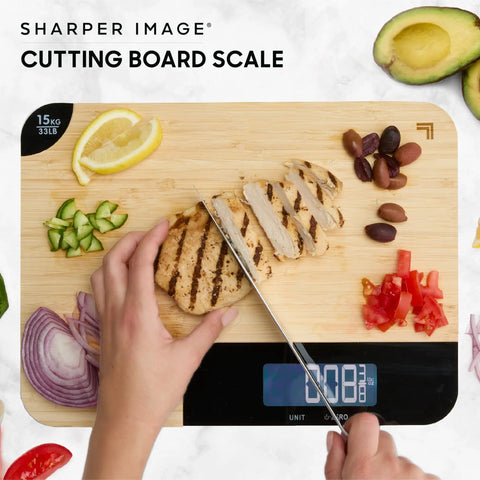 Person slicing chicken on Bamboo Cutting Board With Built In Digital Scale For Quick Meal Prep And Precise Weighing In Grams And Ounces 33 Lb Capacity Multipurpose Prep Board