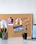 Top Tier Black Push Pin Set With Five Fresh Thumb Tacks And Sharp Steel Point Map Pins For Heavy Duty Cork Board Organization Rock Solid 140 Piece Desk Kit displayed on a cork board with photos.