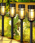 Eight Pack Solar Pathway Lights Outdoor Waterproof 21 Inch Metal And Glass Landscape Driveway Garden Path Lights Auto On Off Easy Install For Yard Walkways And Safe Welcome Glow shown illuminating a garden pathway.