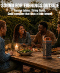 Rugged Aluminum Bluetooth Speaker With 45W Power, BassUp Enhanced Bass, IP68 Waterproof Outdoor Wireless Speaker on table at evening gathering