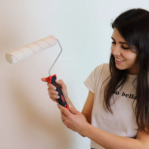 Woman holding paint roller from Eight Piece Painting Roller Kit With Tray And Brushes, Pro Grade Decorating Tools For Home DIY Projects.