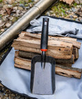 Heavy Duty Ash Shovel For Fire Pits And Grills, Manganese Steel Ember Remover 12.6 Inch displayed on logs outdoors.