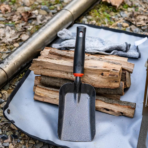 Heavy Duty Ash Shovel For Fire Pits And Grills, Manganese Steel Ember Remover 12.6 Inch displayed on logs outdoors.