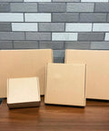 Rock Solid Brown Corrugated Shipping Boxes 6X5X3 Inches Bulk 28 Pack sturdy cardboard mailers on a wooden table.