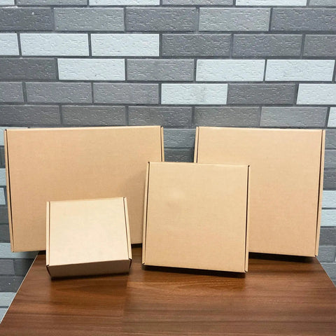 Rock Solid Brown Corrugated Shipping Boxes 6X5X3 Inches Bulk 28 Pack sturdy cardboard mailers on a wooden table.