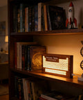 Solid Wood Periodic Table Desk Lamp With Warm Led Glow Usb Powered Science Study Gear A Hella Bright Setup For Chemistry Classrooms Dorms And Teacher Gifts Right Now on a bookshelf with books and decor.