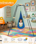 Swing Stand Frame With Sensory Swing And Pod Swing For Kids Heavy Duty X Frame Indoor Outdoor Sensory Hammock With Stand 330 Lbs Capacity Kid Friendly Autism Fun For Home Backyard Park Blue shown in a colorful playroom with a child seated in the swing.