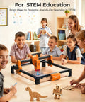 ACMER laser engraver machine (orange/black) on table with kids gathered, 300x300 mm engraving area