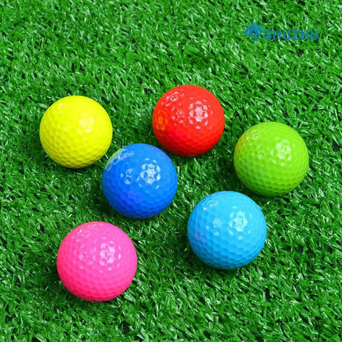 Six Pack Colorful Golf Balls Gift Set For Practice And Training Bright Blue Green Red Yellow on grass