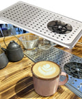Glass Rinser For Espresso Cups And Milk Pitchers With Adjustable Spray Head Fast Rinse Drip Tray Drain Stainless Steel Sink Mount No Fuss Cleanup Multi Angle Cleaning One Hand Operation next to coffee cup on wooden counter
