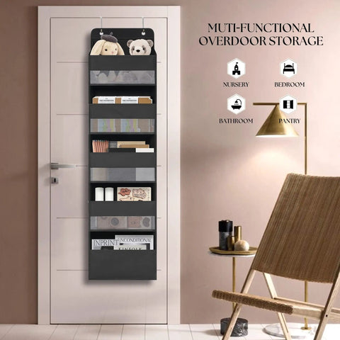 Over Door Organizer With Five Extra Large Pockets Heavy Duty Hanging Storage in black on a white door next to a chair.