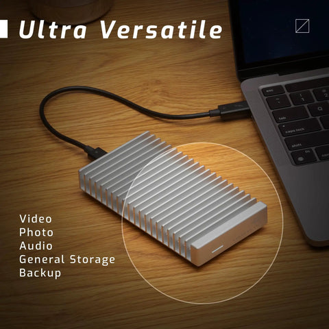 Express 1M2 Portable NVMe SSD Enclosure With USB4 Thunderbolt Compatible USB C Aluminum Heat Sink on wooden desk