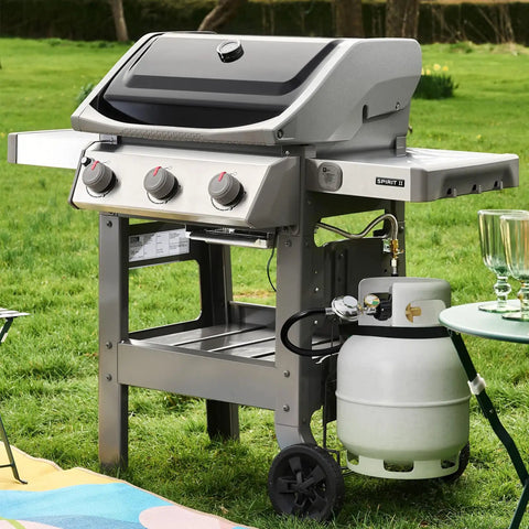 Side view of gas grill with Three Feet Propane Regulator Hose With Tank Gauge For Universal Gas Grill Regulator, set on grass.