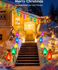 Two Pack Jumbo C9 Christmas Pathway Lights For Outdoor Decor, 17 Feet Total With Ten Multicolor LED Bulbs, Stakes Included, seen along a snow-lined pathway.