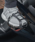 Toe Clip Cage Adapters For Look Delta Pedals convert Peloton pedals to toe clip straps, shown with sneaker on spin bike pedal.