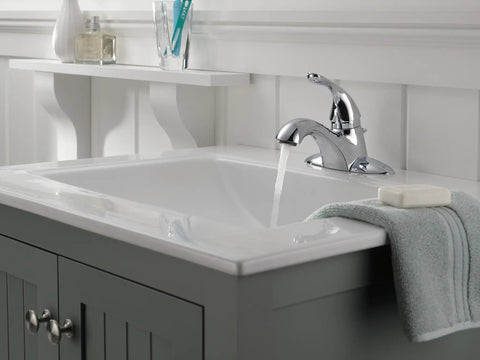 Classic Single Handle Bathroom Faucet Chrome 4 Inch Center Set Solid Brass Body Includes Metal Pop Up Drain Vandal Resistant Lever Hot Cold Graphics WaterSense Certified Lifetime Limited Warranty installed on a white sink.