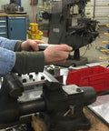 Person using Fold-Up Hex Key Set, 9-Piece SAE Inch Wrench Kit With Steel Handle in workshop with tools and machinery visible
