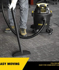 Person using the Beast Mode Wet Dry Vacuum With 6 Gallon Tank And 4 HP Power for carpet cleaning in a home setting.