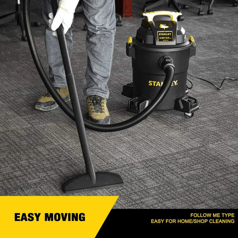 Person using the Beast Mode Wet Dry Vacuum With 6 Gallon Tank And 4 HP Power for carpet cleaning in a home setting.
