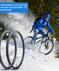 Cyclist riding in snow with Two Pack 700C Self Sealing Bike Tubes 35C To 43C Puncture Resistant AV48mm Valve in foreground.