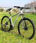 Mountain bike with non slip bike handlebar grips for mountain BMX beach cruiser and kids bikes, outdoors in a grassy field.