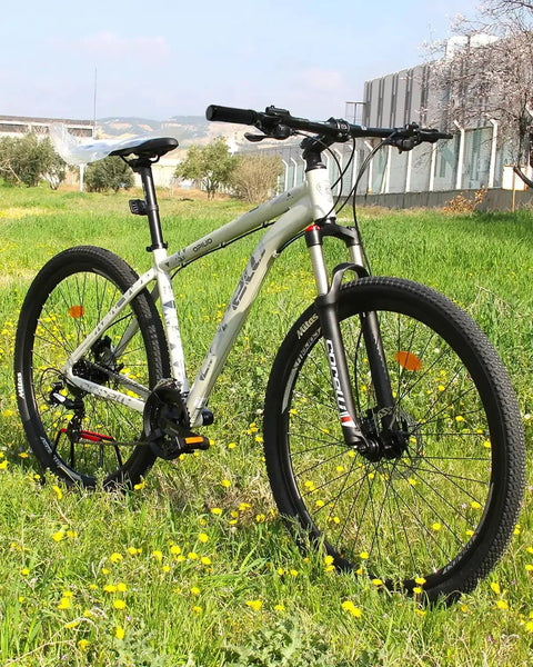 Mountain bike with non slip bike handlebar grips for mountain BMX beach cruiser and kids bikes, outdoors in a grassy field.