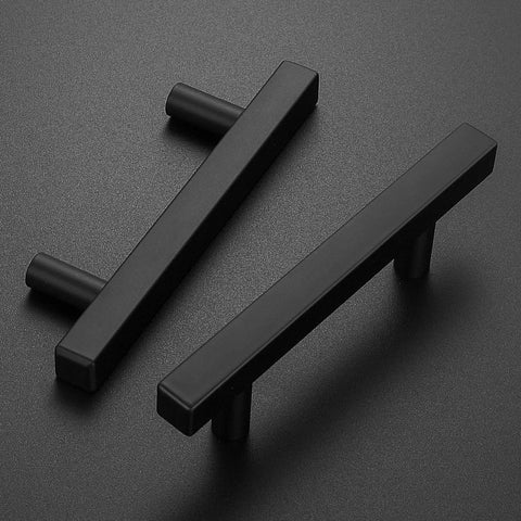 Real Deal Matte Black Cabinet Handles With Slick Square Edges 3 Inch Hole Centers And Heavy Duty Stainless Steel Build For Drawers Dressers And Cupboards In A Thirty Pack - Close-up of two matte black handles on a dark background.