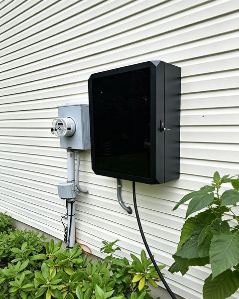 Lock Down Your EV Charger Setup With This Built Like A Tank Outdoor Enclosure To Block Tampering And Weather Damage For Level Two Charging Stations In Driveways Or Garages Featuring Heavy Duty Metal Guard mounted on wall.