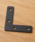 Black metal L bracket from Flat Corner Braces For Wood Frames, 20 Piece Kit With L Brackets And Mending Plates, 50 By 50mm Picture Frame Fasteners.