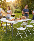 People enjoying a picnic outdoors with Four Foot Go To Folding Picnic Table With Carrying Handle Easy To Fold And Store Portable