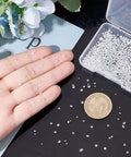 Hand holding Loose CZ Diamond Stones Kit 2400 Clear Cubic Zirconia Rhinestones In 8 Sizes From 0.8mm To 2.5mm Glass