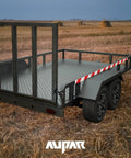 Rear view of a steel trailer with Heavy Duty Steel Trailer Gate Spring Latch Repair Kit 819T Anti Rust Black gate installed, outdoors.