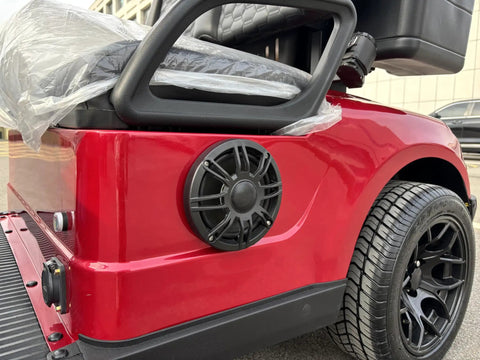 Red 48 Volt 105 Ah Lithium Electric Golf Cart With Spacious Built In Insulated Cooler For Smooth Course Cruising showing rear speaker and wheel.