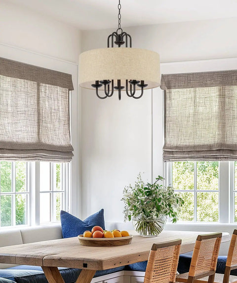 Gwenyth 20 Inch Modern Farmhouse 5 Light Drum Chandelier With Oatmeal Linen Shade Rustic Arched Metal Hanging Fixture In Oil Rubbed Bronze Finish For A Warm Cozy Dining Room Vibe over a farmhouse dining table.