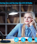 Woman smiling under desk lamp with Ridiculously Bright 100W Equivalent LED A19 Bulbs 1500 Lumens 5000K Daylight White No Flicker