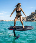 Woman riding High Power Electric Hydrofoil Surfboard With Full Carbon Fiber Build And 8000W Motor E Foil Jetboard on ocean