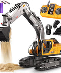 RC excavator toy with yellow body, gray arm, bucket, remote, and two purple rechargeable batteries.