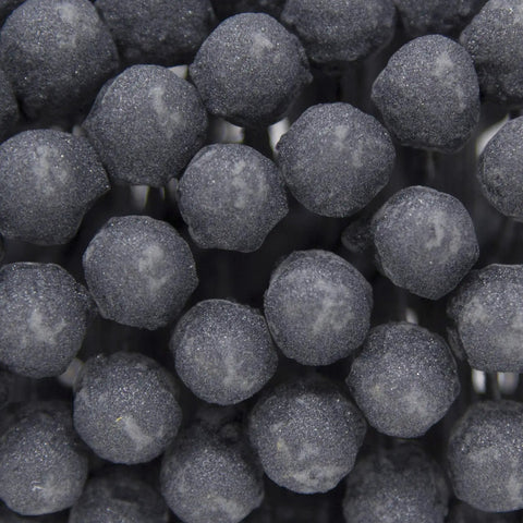 Close-up of abrasive beads from FLEX-HONE Deburring And Finishing Tool Pro Grade 4 1/4 Inch Diameter 240 Grit Silicon Carbide