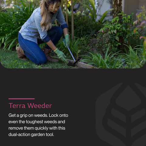 Terra Garden Weeder Hand Tool With Dual Heads For Precision Weeding in use on tough soil by a gardener in a yard.