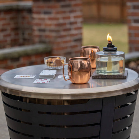 Tabletop Fire Pit Cover For Patio Pits 25.6 Inch Durable Stainless Steel Lid Weather Resistant Outdoor Fire Pit Protector Converts Fire Pit Into A Table For Chill Entertaining Gold with drinks and cards on top