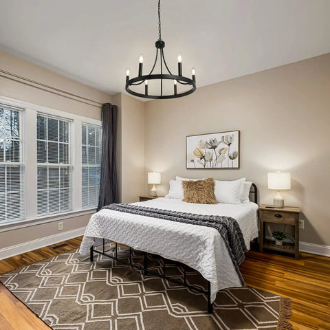 Bedroom with Six Light Wagon Wheel Chandelier In Black Industrial Farmhouse Style over bed, rustic decor accents visible