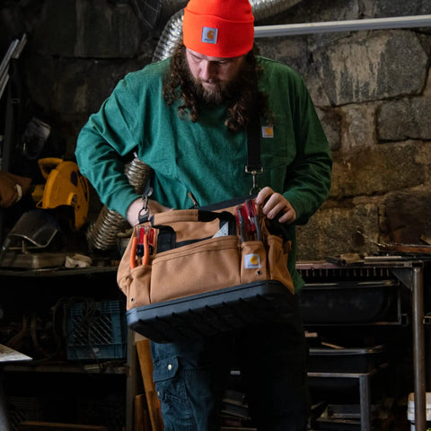 Man holding Onsite Tool Bag For Pros Built Tough Durable Water Resistant 16 Inch Heavyweight Tool Organizer with Molded Base